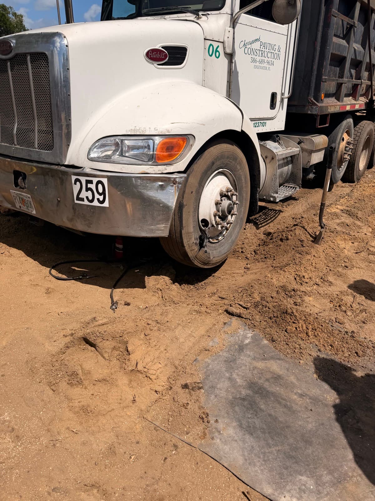 Construction truck tire service at a job site in Volusia County, Florida — K & W handles heavy-duty commercial truck tires where the equipment is working