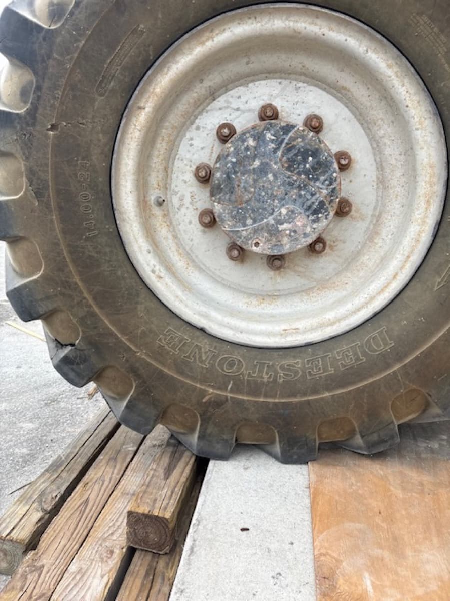 Close-up of heavy equipment tire being inspected by K & W Mobile Tire Service — tread and sidewall condition check for construction equipment and agricultural machinery
