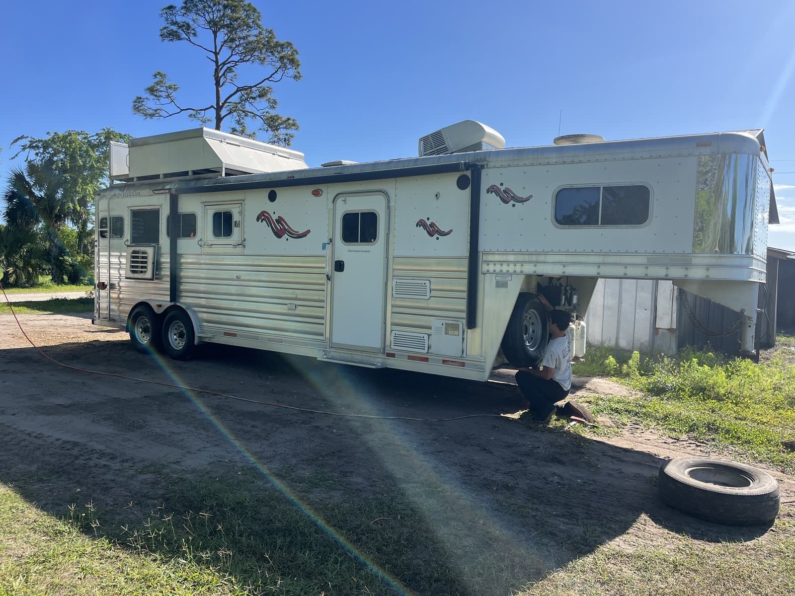 Horse trailer receiving on-site ST tire replacement from K & W Mobile Tire Service at a Central Florida ranch — equestrian trailer tire safety