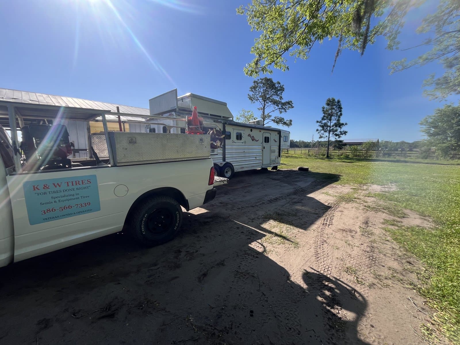 K & W Mobile Tire Service truck at a ranch in Volusia County, Florida performing mobile horse trailer tire repair on-site — we come to farms, barns, and equestrian properties